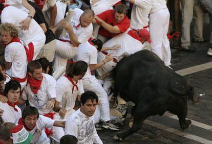 A bull slams into runners during the sixth Running of the Bulls in 2007.