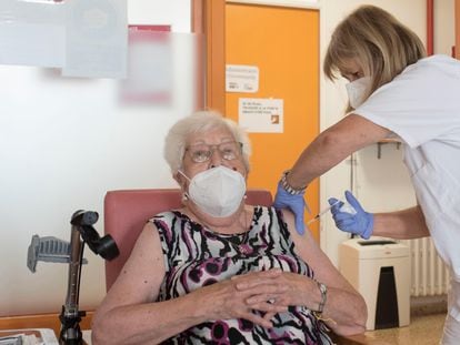 A nursing home resident receives a third shot of a Covid-19 vaccine.