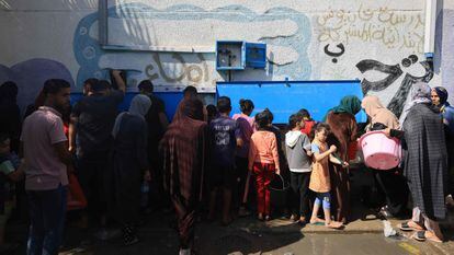 Gazans go to a water supply point inside a UN refugee camp in Khan Younis, Gaza Strip, on Oct. 20, 2023.