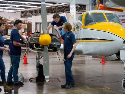 Students at the Pittsburgh Institute of Aeronautics from left: Nikki Reed, William Onderdonk, Jeffrey Natter and Joshua Lindberg study an engine on a Cessna 310 aircraft in West Mifflin, Pa., Tuesday, May 2, 2023.