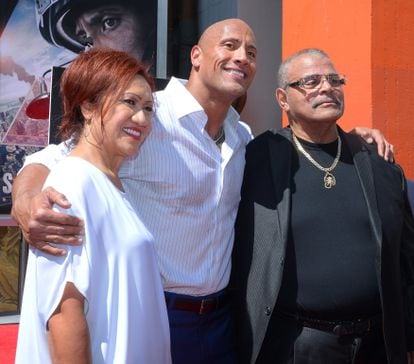 Johnson poses with his father, professional wrestler Rocky Johnson, and his mother, after stamping his handprint at the Chinese Theater in Los Angeles in 2015.