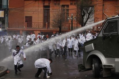 Police fire a water cannon at medical students Tuesday in La Paz.