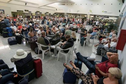 Tourists await their flights in Menorca airport.