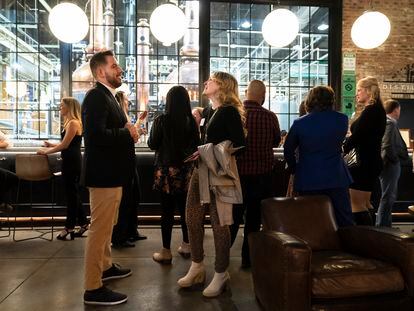 People mingle at a Philadelphia Distilling Daters Mixer Hosted by Date Him Philly, in Philadelphia, Tuesday, Nov. 14, 2023.