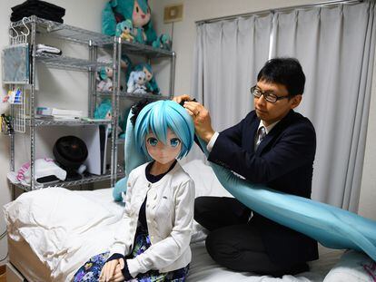 Akihiko Kondo with a life-sized doll of Hatsune Miku, the virtual singer he married in 2018.