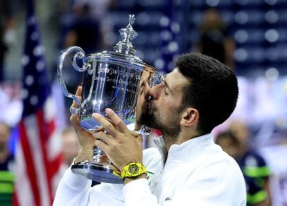 Serbia's Novak Djokovic celebrates with the trophy after winning the U.S. Open.