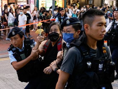 Police detaining the activist Chan Po Ting in Hong Kong on Sunday.