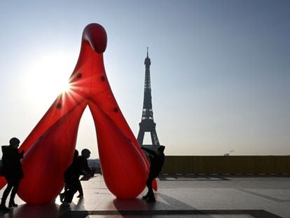 Members of the group 'Gang du clito' drag an inflatable clitoris in Paris on March 8, 2021.