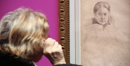 A visitor examines one of the works by Degas at the exhibition in Fundación Canal.