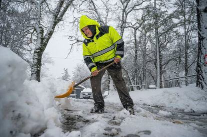 Hayes Condon shovels snow in his driveway on Tuesday, February 28, 2023, in Colfax, California.