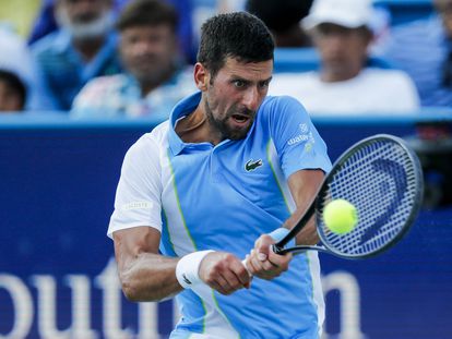 Novak Djokovic returns a shot against Carlos Alcaraz during the men's singles final of the Western and Southern Open tennis tournament at Lindner Family Tennis Center.