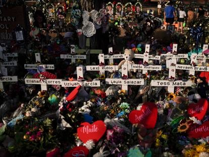 Flowers are piled around crosses with the names of the victims killed in a school shooting as people visit a memorial at Robb Elementary School to pay their respects May 31, 2022, in Uvalde, Texas.