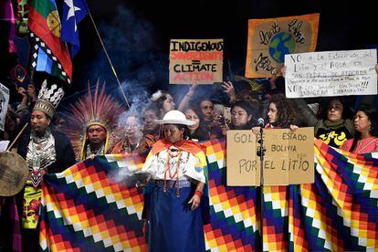Members of indigenous communities speak onstage at the climate change rally. They hold signs against the ”coup in Bolivia” and lithium mining in Atacama, the world’s driest desert.