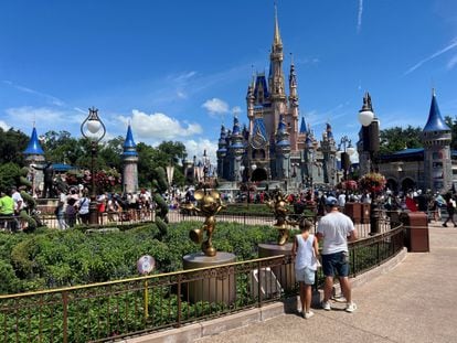 People gather ahead of the "Festival of Fantasy" parade at the Walt Disney World Magic Kingdom theme park in Orlando, Florida