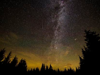 A meteor streaks across the sky during the annual Perseid meteor shower, in August 2021, in West Virginia.