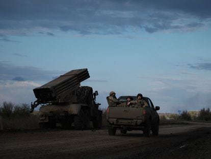 Ukrainian soldiers drive past a BM-21 Grad multiple rocket launcher on the frontline near Bakhmut, Donetsk region, on April 23, 2023.