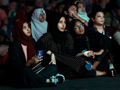 A group of women watch a World Cup game on a giant screen in the Fan Zone of Doha, Qatar, circa 2022.