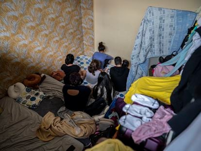 The seven members of a Peruvian immigrant family in the room they share in a basement in Madrid's Usera district.