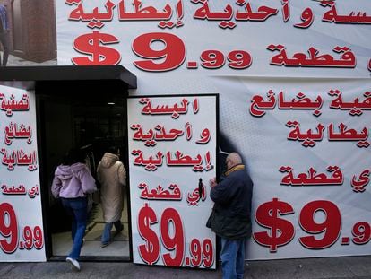 Store displays advertising in Arabic that reads "Italian clothes and shoes for $9.99" in Beirut, Lebanon, on Wednesday, March 1, 2023.