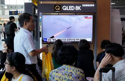 A TV screen shows a file image of North Korea's missile launch