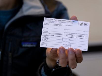A nurse practitioner holds a COVID-19 vaccine card at a New York Health and Hospitals vaccine clinic in the Brooklyn borough of New York on Jan. 10, 2021.