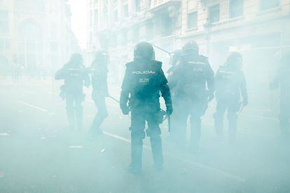 Riot police protecting the National Police headquarters on Via Laietana in Barcelona.