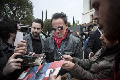 Bruce Springsteen signing autographs for fans.