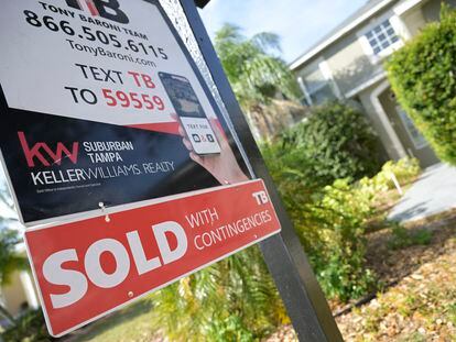 A real estate sign is posted outside of a recently sold home, on February 21, 2023, in Valrico, Florida.