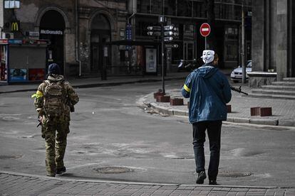 A member of the Ukranian forces patrols the streets of Kyiv with a Guy Fawkes mask on, in a file photo from February 27.