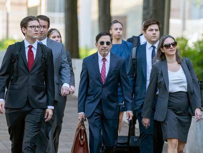 Justice Department prosecutors – including Kenneth Dintzer, center – arrive at the federal courthouse in Washington, D.C.