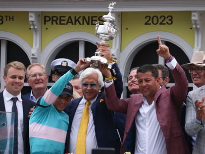 Bob Baffert, center, trainer of National Treasure, and jockey John Velazquez, left, help hoist the Woodlawn Vase after winning the148th running of the Preakness Stakes horse race at Pimlico Race Course, Saturday, May 20, 2023, in Baltimore.