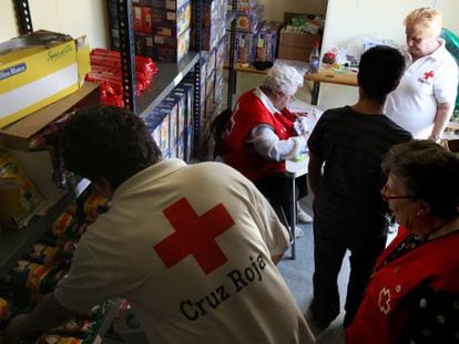 Red Cross staff hand out parcels at a food bank in Tres Cantos, Madrid.