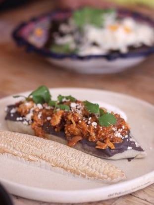 Bean tlacoyo with pressed chicharrón.