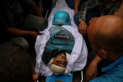 Friends and relatives mourn the bodies of Palestinian journalists Muhammad Sobh and Saeed Al-Taweel, who were killed during their work by Israeli air strikes on October 10, 2023 in Gaza City, Gaza. 