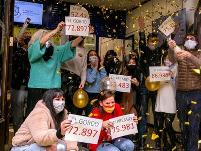 Workers at Madrid's famous "Doña Manolita" lottery sales agency celebrating the fact that they sold 'décimos' from this year's first and third prizes.