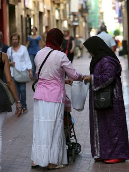 Two women wearing headscarves in the streets of Reus, Tarragona.