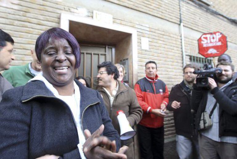 A woman bursts into tears after an eviction against her is stopped in Zaragoza Thursday.