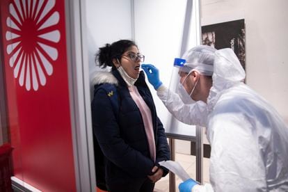 A medical worker takes a Covid-19 throat swab sample from a passenger at Berlin-Brandenburg Airport on November 26.