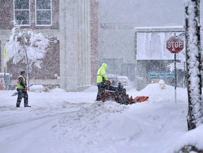 A worker plows snow on a street, Tuesday, March 14, 2023, in Pittsfield, Massachussetts.
