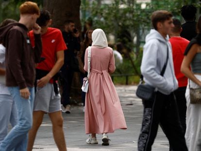 A Muslim woman wears an ankle-length tunic in a street in Nantes, France on August 29, 2023.