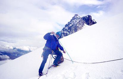 Mountain guide Janier Díaz measures the depth of the snowpack on the Tolima glacier at 16,400 feet (5,000 meters).