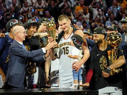NBA commissioner Adam Silver presents Denver Nuggets center Nikola Jokic (15) the Bill Russell NBA Finals MVP Award after winning the 2023 NBA Finals against the Miami Heat at Ball Arena.