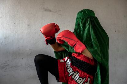 An Afghan woman who practices Muay Thai, or Thai boxing, poses for a photo in Kabul, Afghanistan. The ruling Taliban have banned women from sports, as well as barring them from most schooling and many realms of work. 