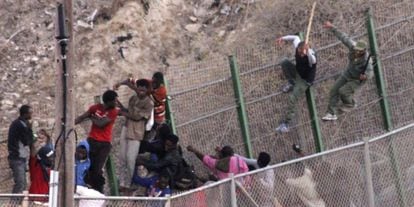 Moroccan police beat immigrants at the border fence on July 18.