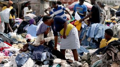 Haitians buy clothes at a street market on Sunday.