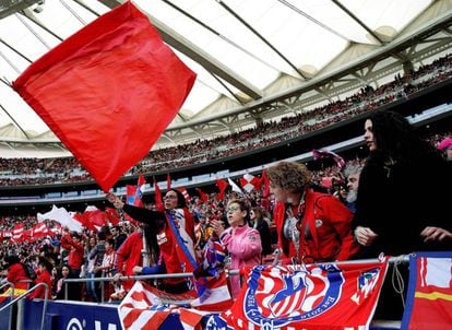 Atlético fans wave flags during the match.