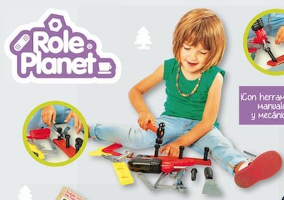 A girl plays with a toy toolkit.