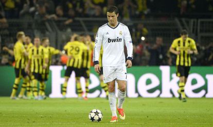 Real Madrid&#039;s Cristiano Ronaldo reacts as Dortmund&#039;s players celebrate a goal during the Champions League semifinal first leg.