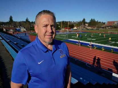 Joe Kennedy, a former assistant football coach at Bremerton High School in Bremerton, Wash., poses for a photo March 9, 2022, at the school's football field