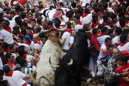 Runners and bulls get trapped at the entrance to the ring, in 2013.